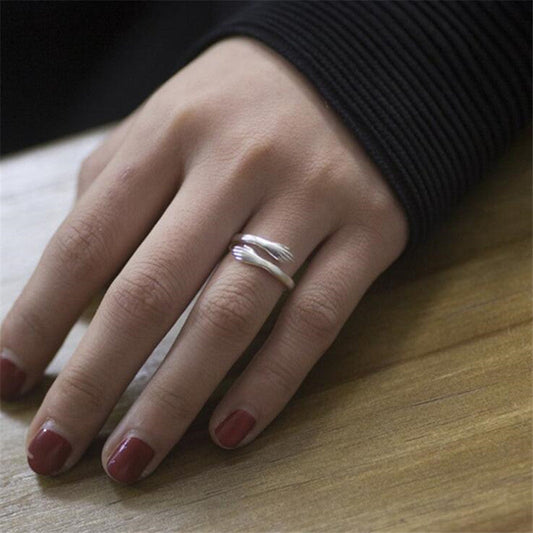 Adjustable Hugging Hands Ring in Alloy for Women and Men – Symbol of Love and Comfort.