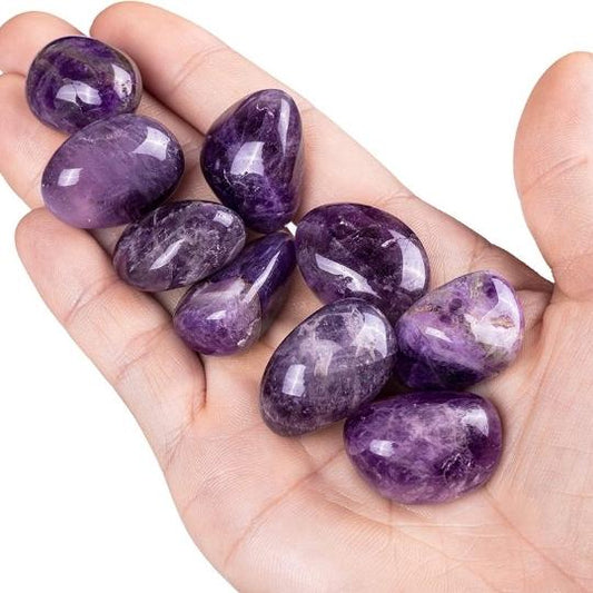 Genuine Amethyst tumbled stones showcasing their rich purple hues and spiritual healing properties.