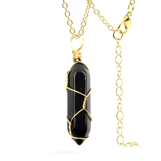 Close-up of a Black Onyx Necklace with a handcrafted gold wire-wrapped gemstone and stainless steel chain.