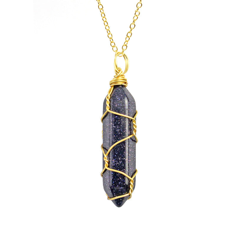 Close-up of a Blue Goldstone Necklace featuring a sparkling gemstone wrapped in handcrafted gold wire with a stainless steel chain.