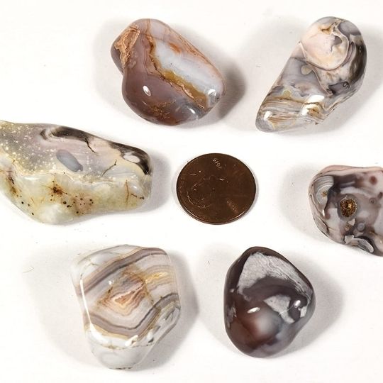 Polished Botswana agate tumbled stones displaying their banded patterns and spiritual healing properties.