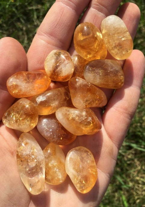 Polished Citrine tumbled stones showcasing their warm golden hues, healing properties, and spiritual benefits.