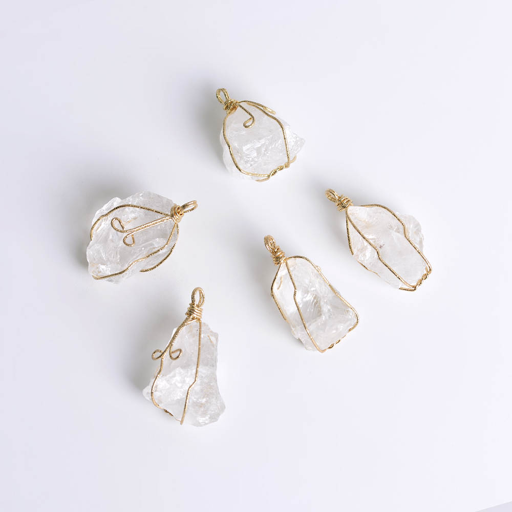 Elegant clear quartz gemstone necklace with intricate gold wire wrapping, perfect for men and women seeking balance and clarity.