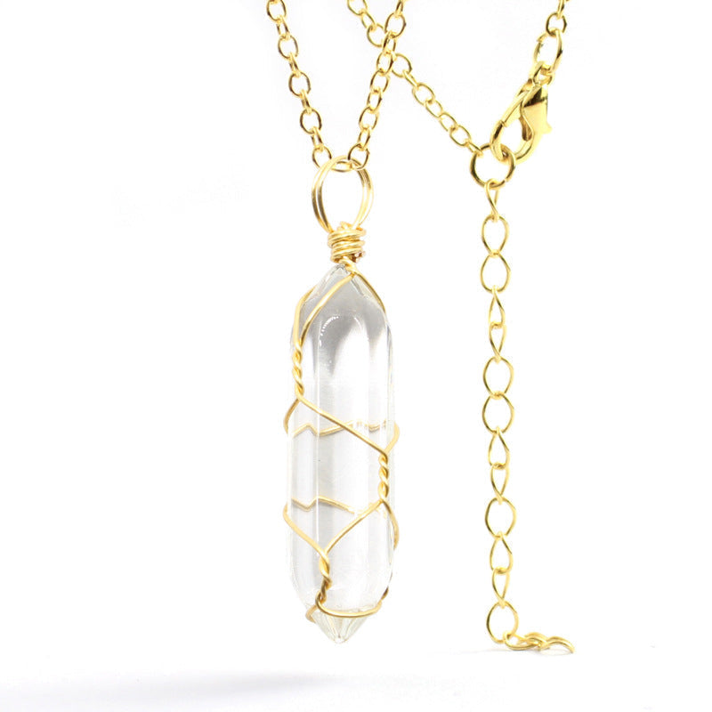 Close-up of a Clear Quartz Necklace featuring a transparent gemstone wrapped in handcrafted gold wire with a stainless steel chain.