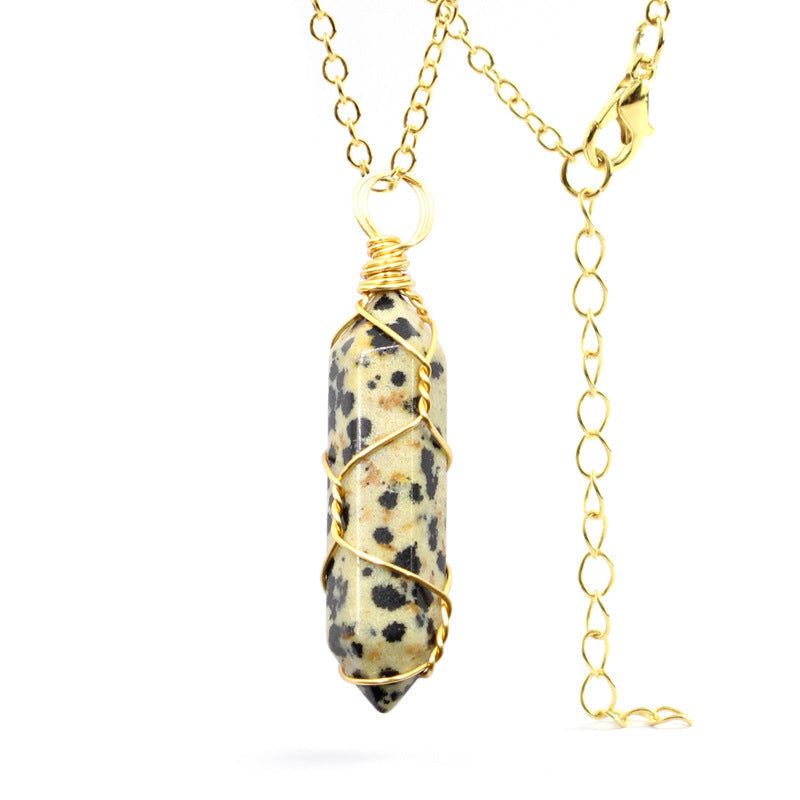 Close-up of a Dalmatian Jasper Necklace featuring a speckled gemstone wrapped in handcrafted gold wire with a stainless steel chain.