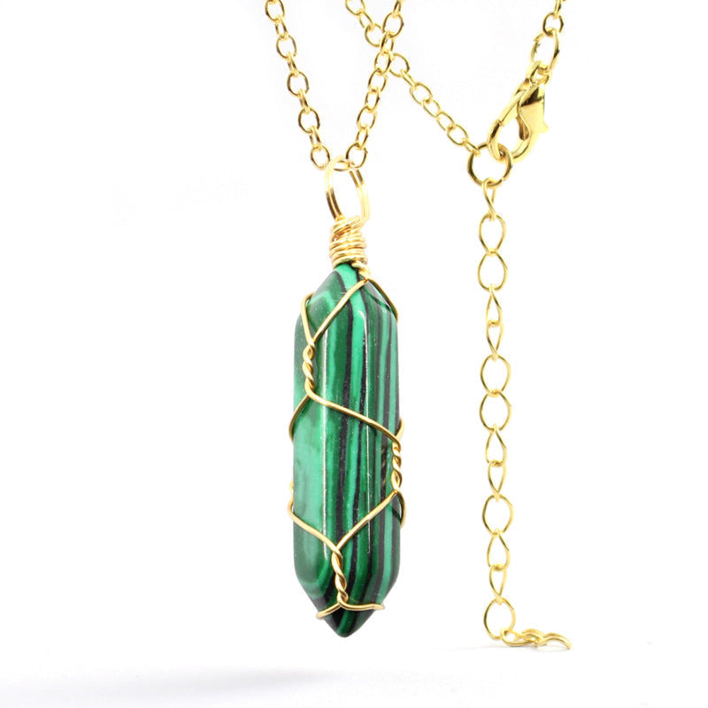 Close-up of a Malachite Necklace featuring a vibrant green gemstone with natural bands, wrapped in handcrafted gold wire with a stainless steel chain.