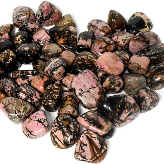 Polished Rhodonite tumbled stones showcasing their pink and black patterns, highlighting their emotional healing properties.